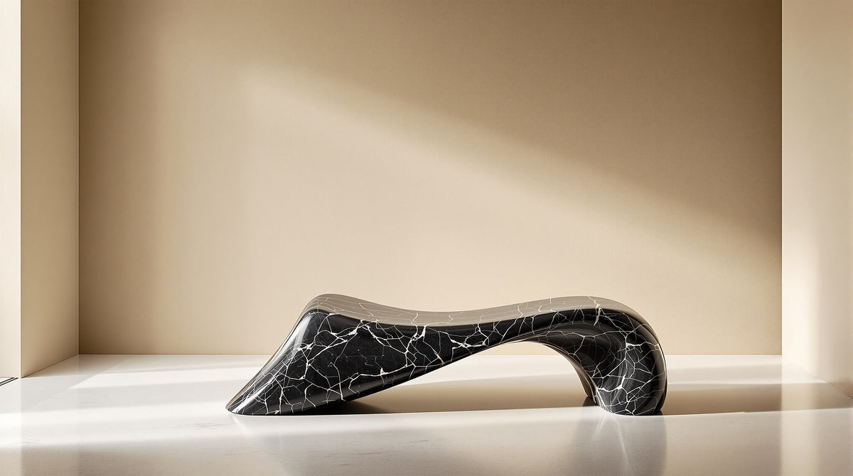 Sculptural black Marquina marble bench with a flowing curved silhouette in a plaster gallery corridor